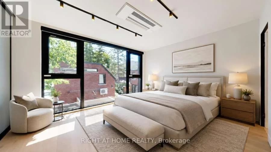 Bedroom with floor-to-ceiling windows and a reading chair