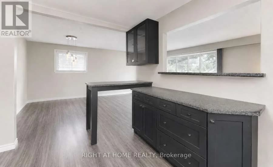 Open space with dark cabinets and a breakfast bar