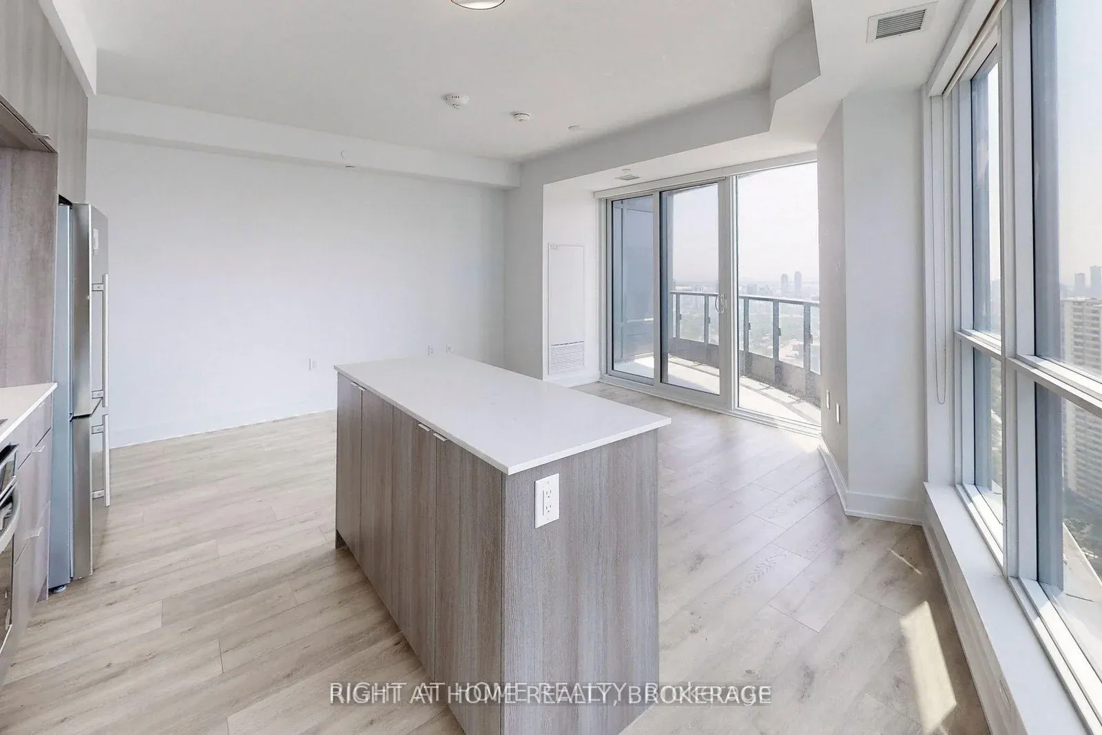 Kitchen island beside a wall of windows