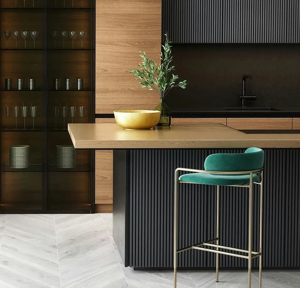Modern kitchen with a stone island and a green stool